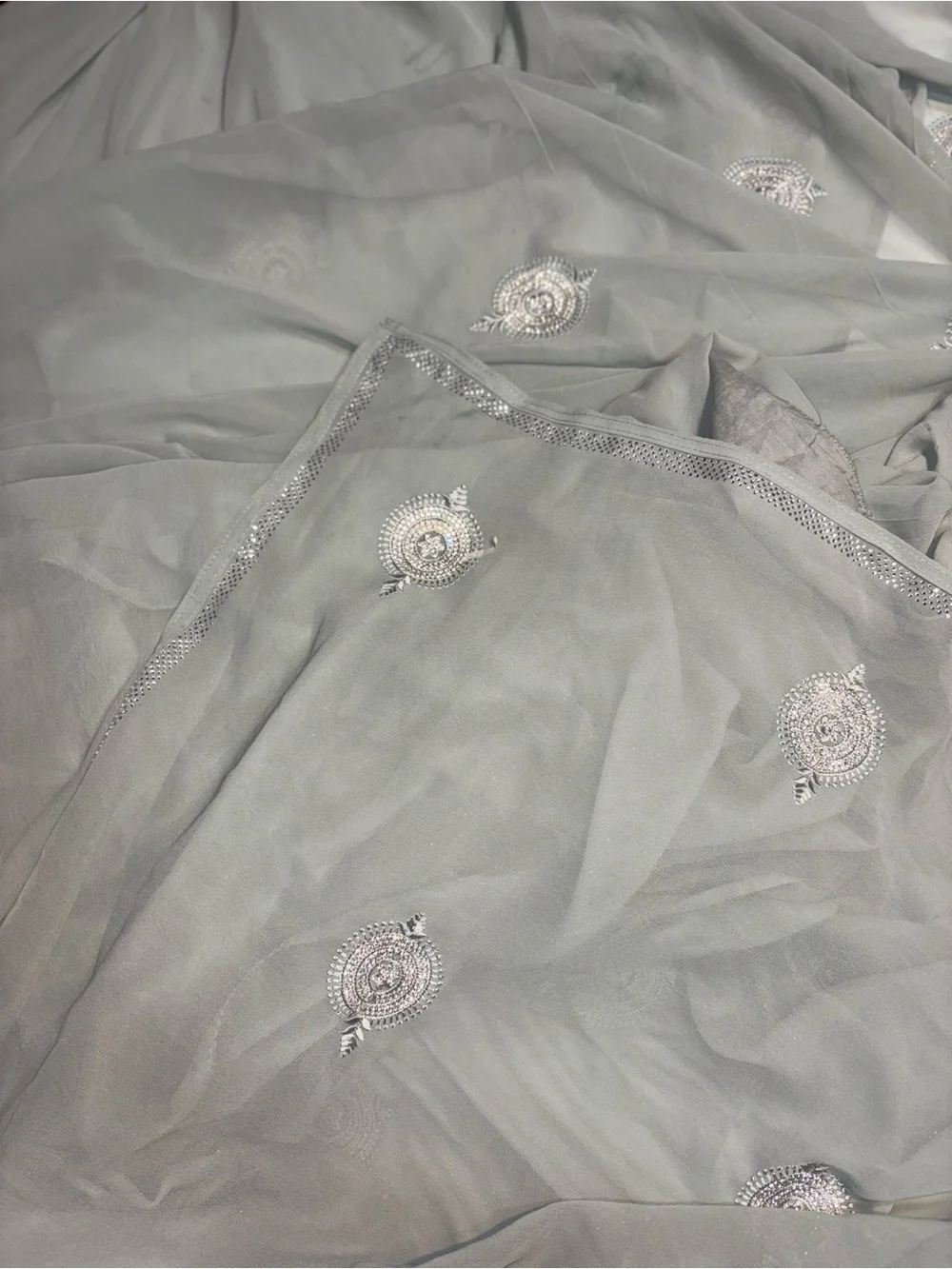 218” Legnth sage green draped saree features delicate silver embroidery